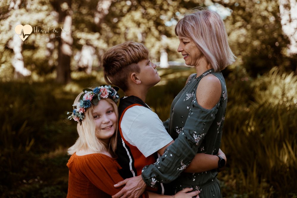 lady and girl and boy hugging