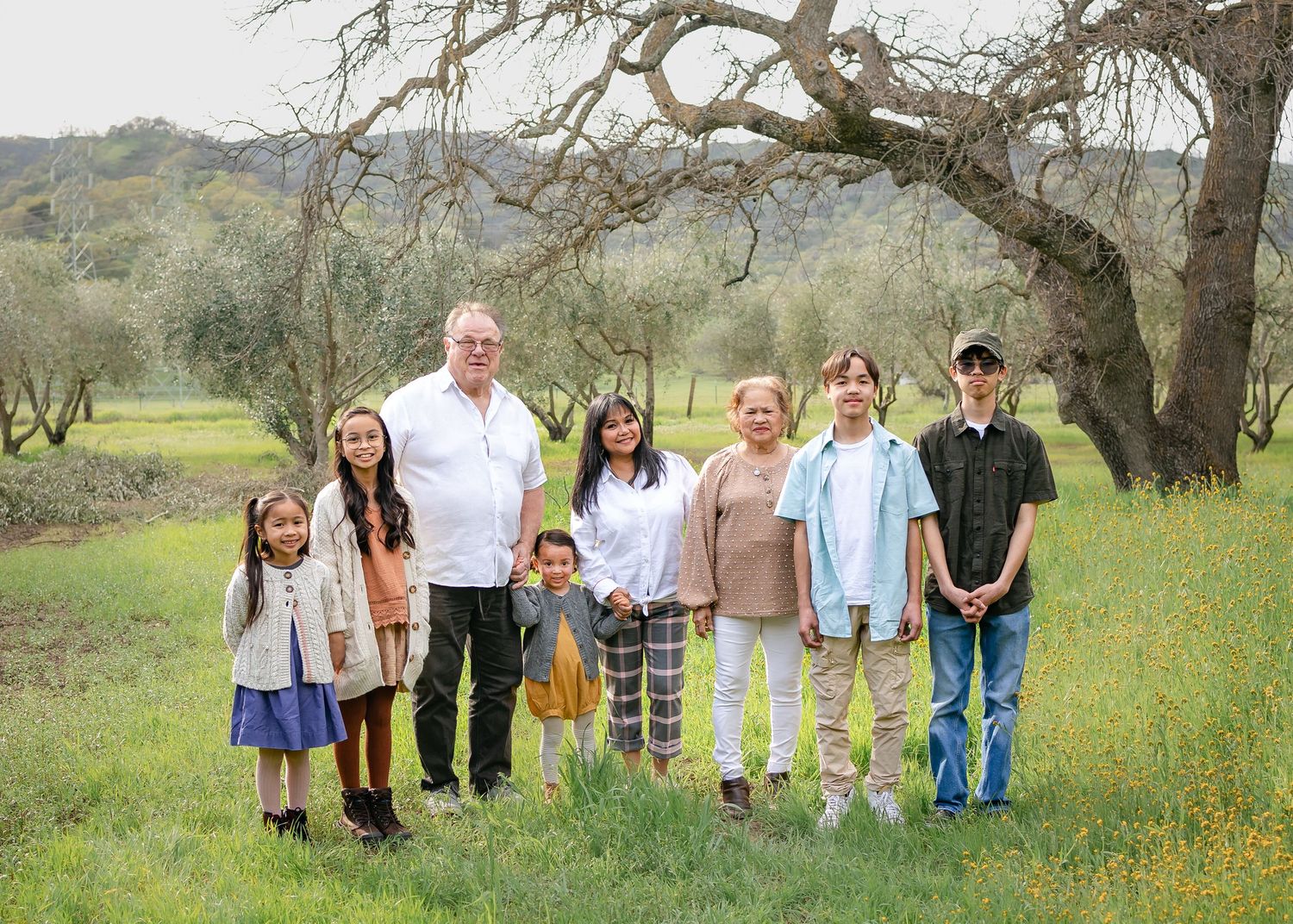 Extended family portrait in front of a tree at Soul Food Farm