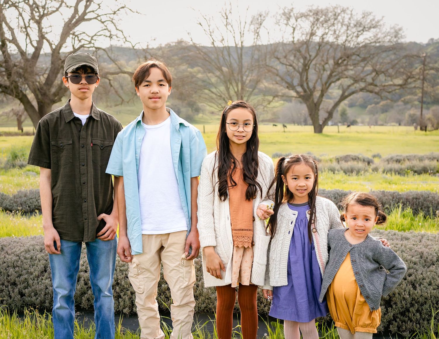 Five grandkids smile in front of lavender at Soul Food Farm