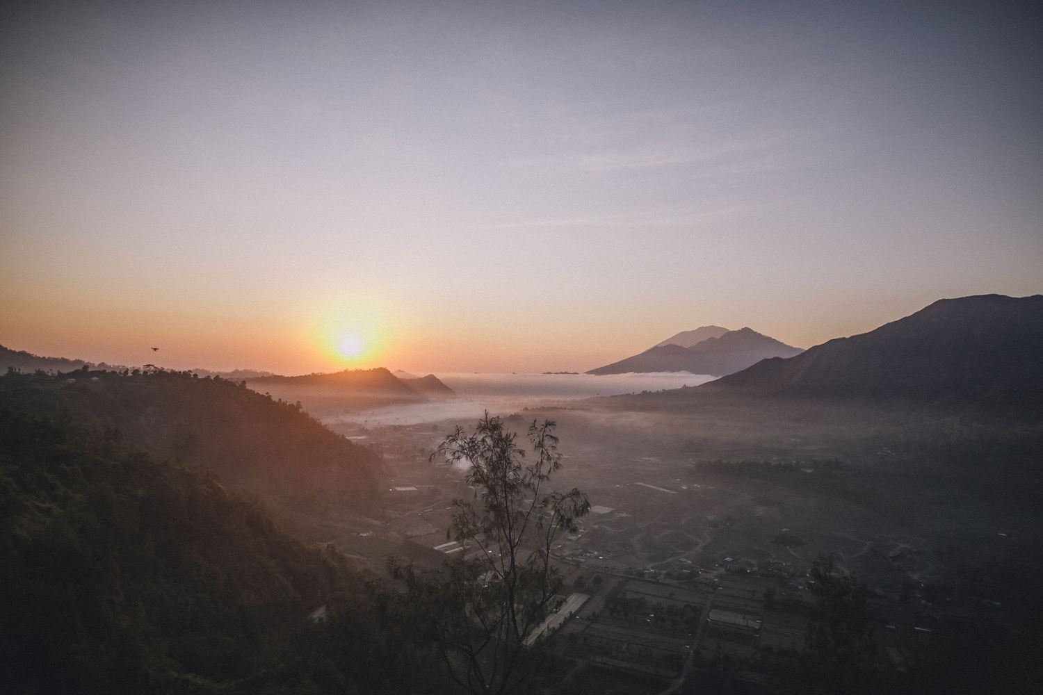 Scenic mountain landscape at sunset with fog rolling through the valleys.