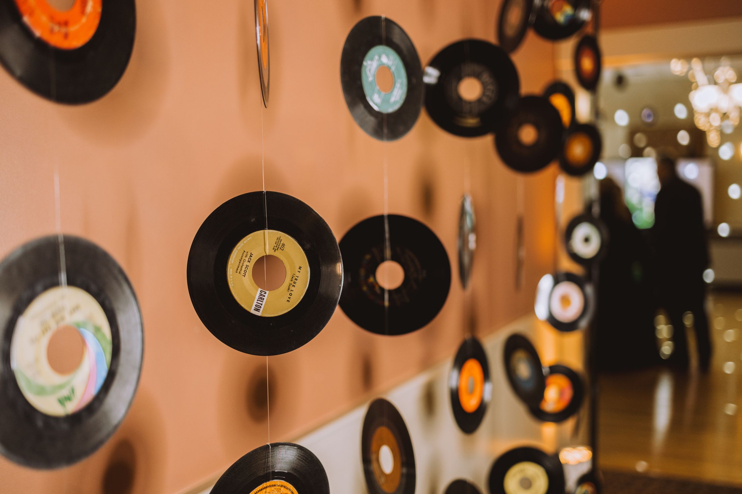 Vintage vinyl records hanging as wall decorations at a retro-themed party.