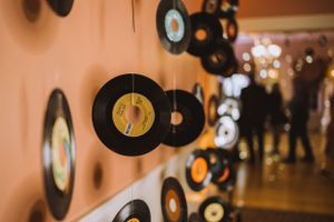 Vinyl records suspended from ceiling creating a unique wall display installation.