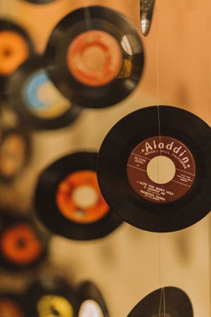 Close-up of vintage Aladdin record label among hanging vinyl records in party decoration.