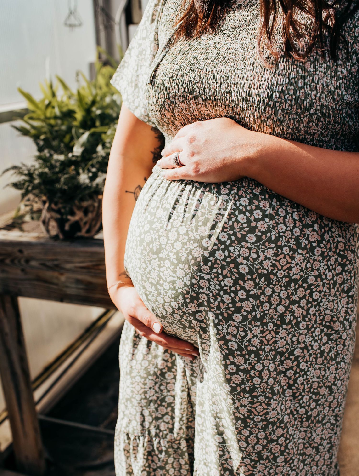 Mom holds belly for maternity session in Farmington ME