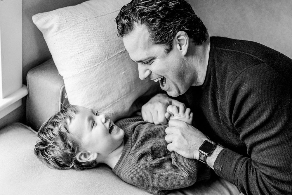 lifestyle family indoor photos dad and son tickles