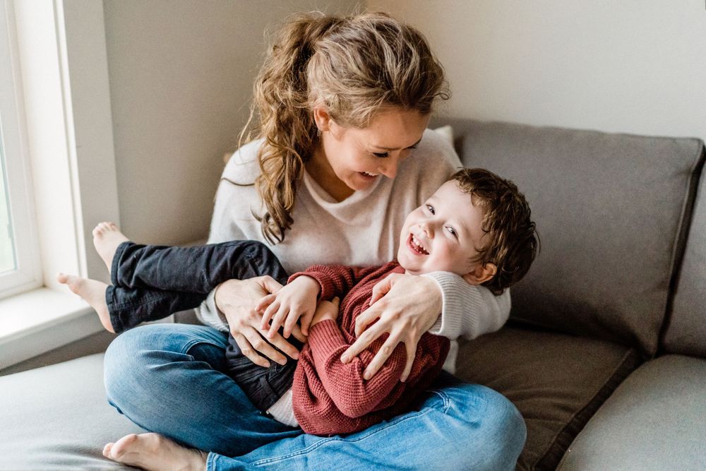mother and son tickles and snuggles lifestyle image