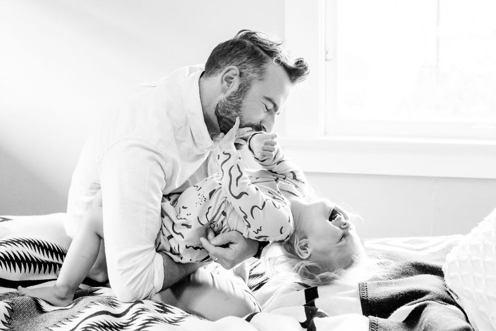Dad playing with daughter on the bed