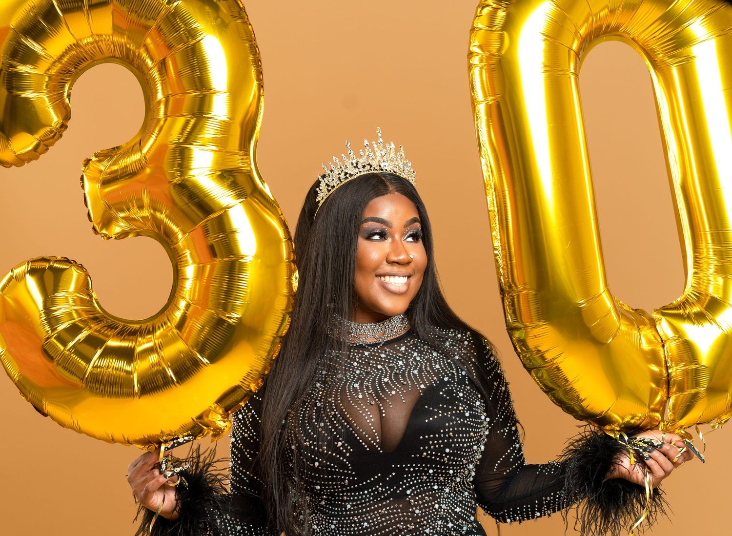 A celebration scene with gold number balloons showing '30' against an orange background.