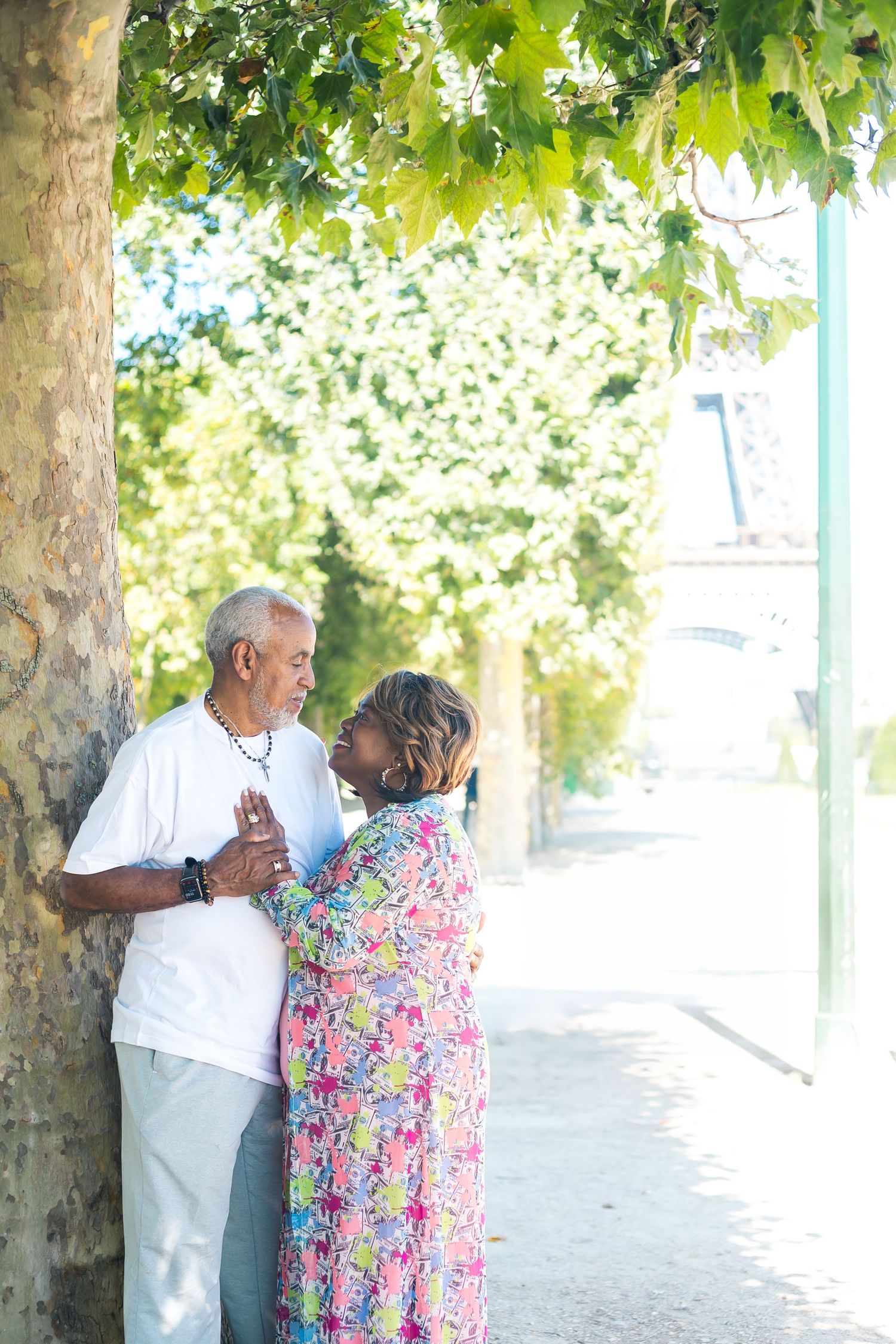 Older black couple looking at each other in front of Eiffel Tower