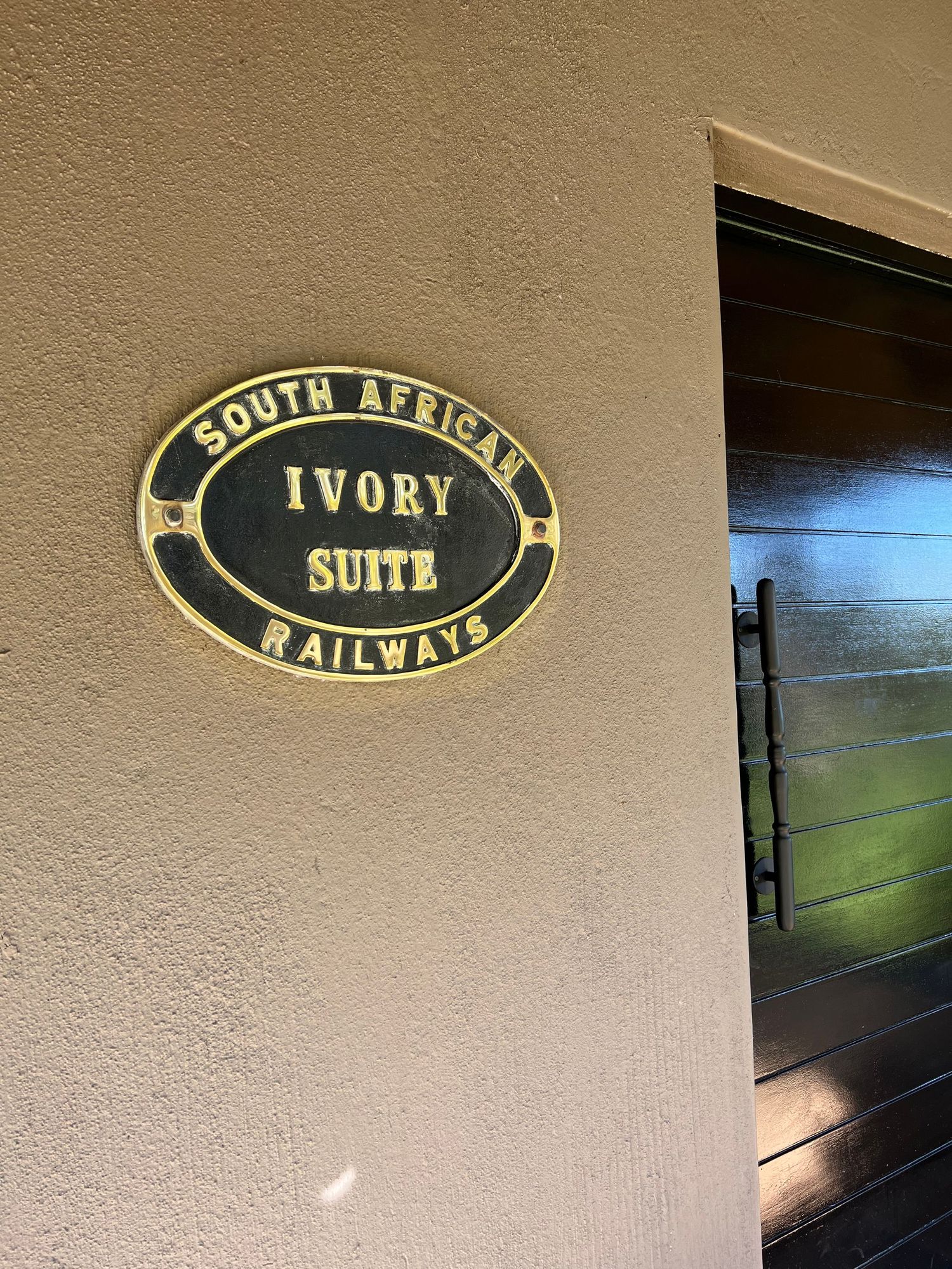 Vintage railway signage displaying 'South Africa Railways' and 'Ivory Suite' text.