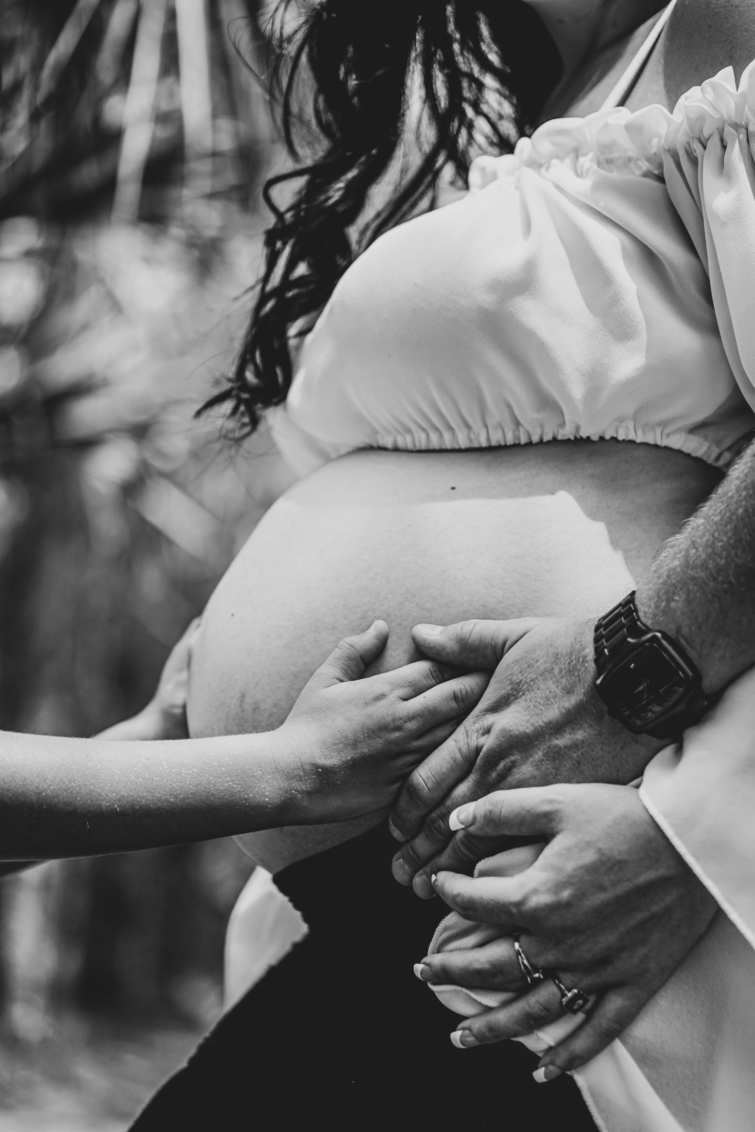 lifestyle maternity photography of dad holding moms belly