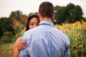 couple embrace in sunflower field