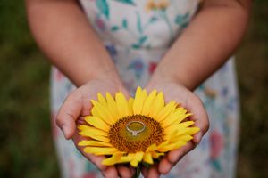 engagement ring sits on sunflower