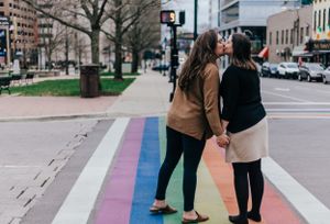 couple kiss on crosswalk after proposal