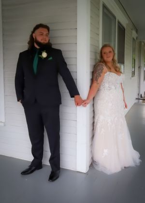 Artistic black and white sequence of couple posing against white wall in formal wedding attire.