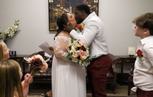 A couple in formal wedding attire share an intimate moment together during their special day.