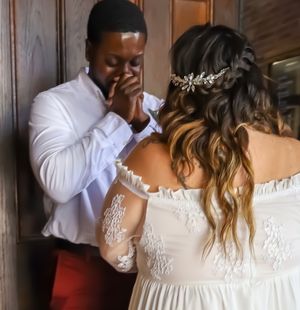 Intimate wedding moment photographed in soft indoor lighting with lace details.