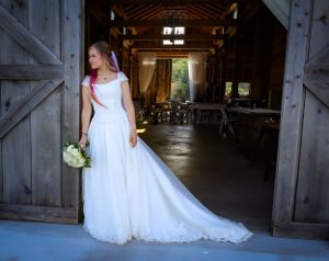A flowing white wedding dress photographed in sequence against a rustic barn door backdrop.