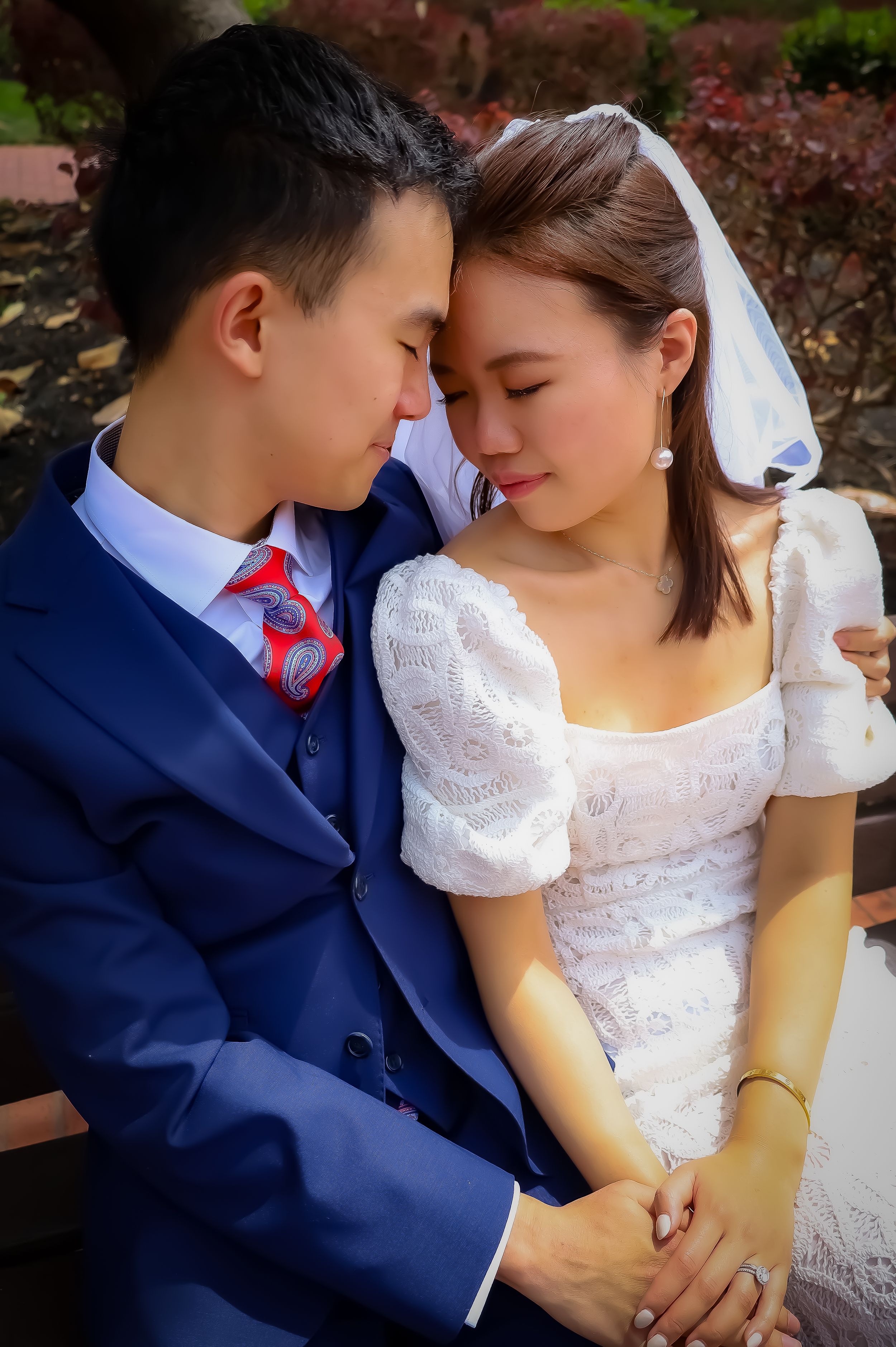 Intimate moment between newlyweds as they share a tender moment on their wedding day.