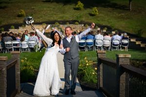 A wedding celebration on an outdoor patio with guests seated in the background.