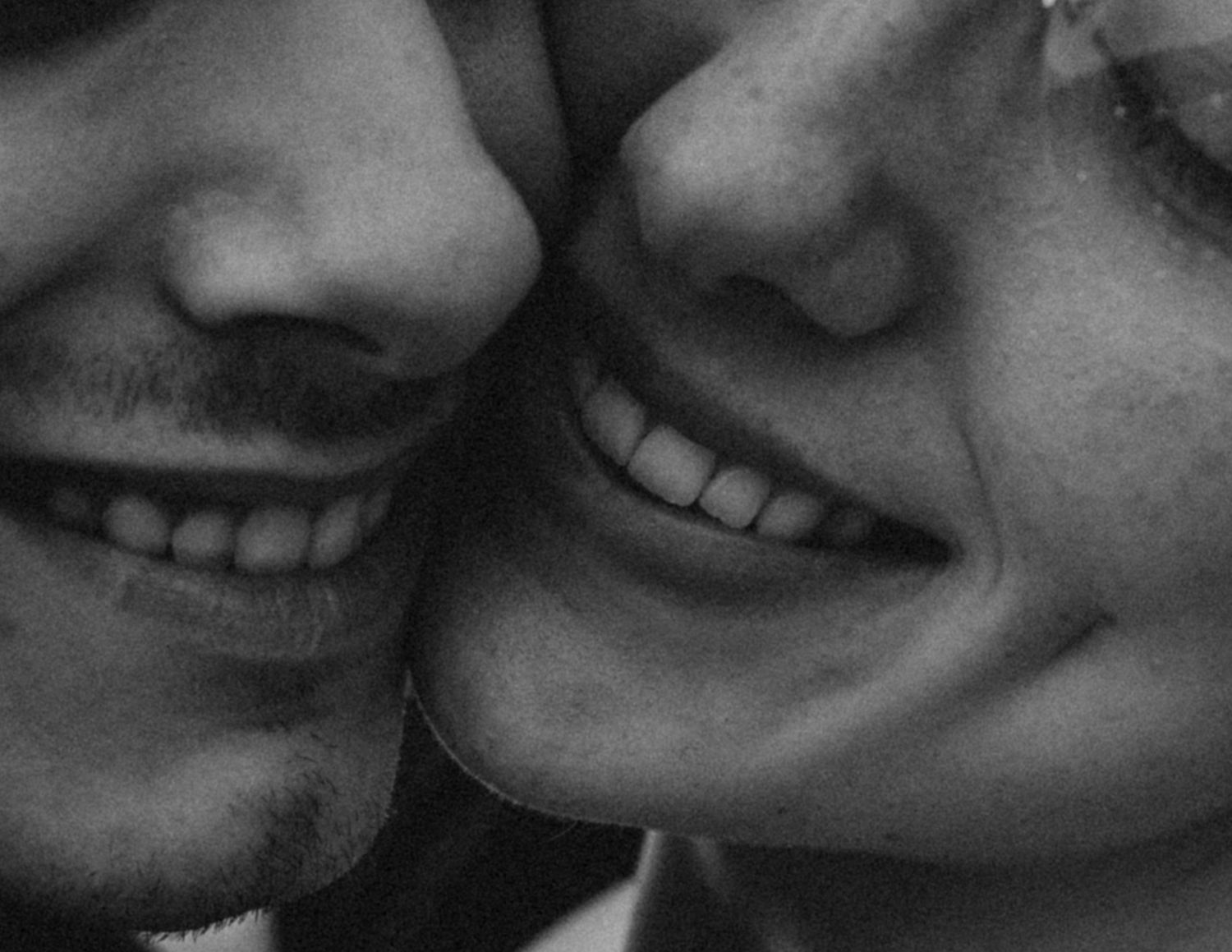 Close-up black and white portrait of a smiling couple during their Abbotsford engagement session.