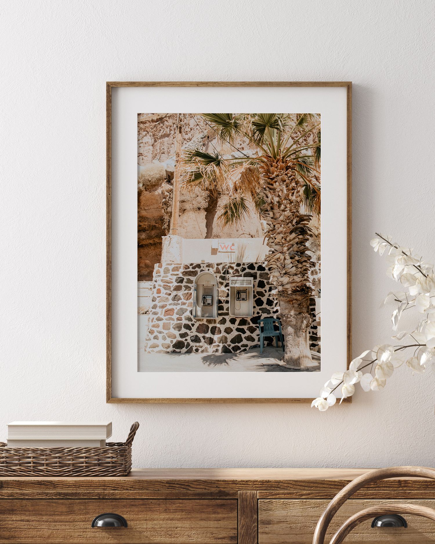 Sepia-toned framed photograph of rustic stone architecture with palm trees.