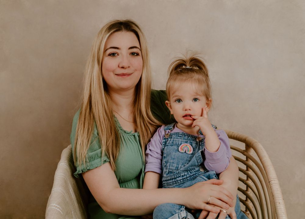 Mum and daughter sitting on a wooden chair