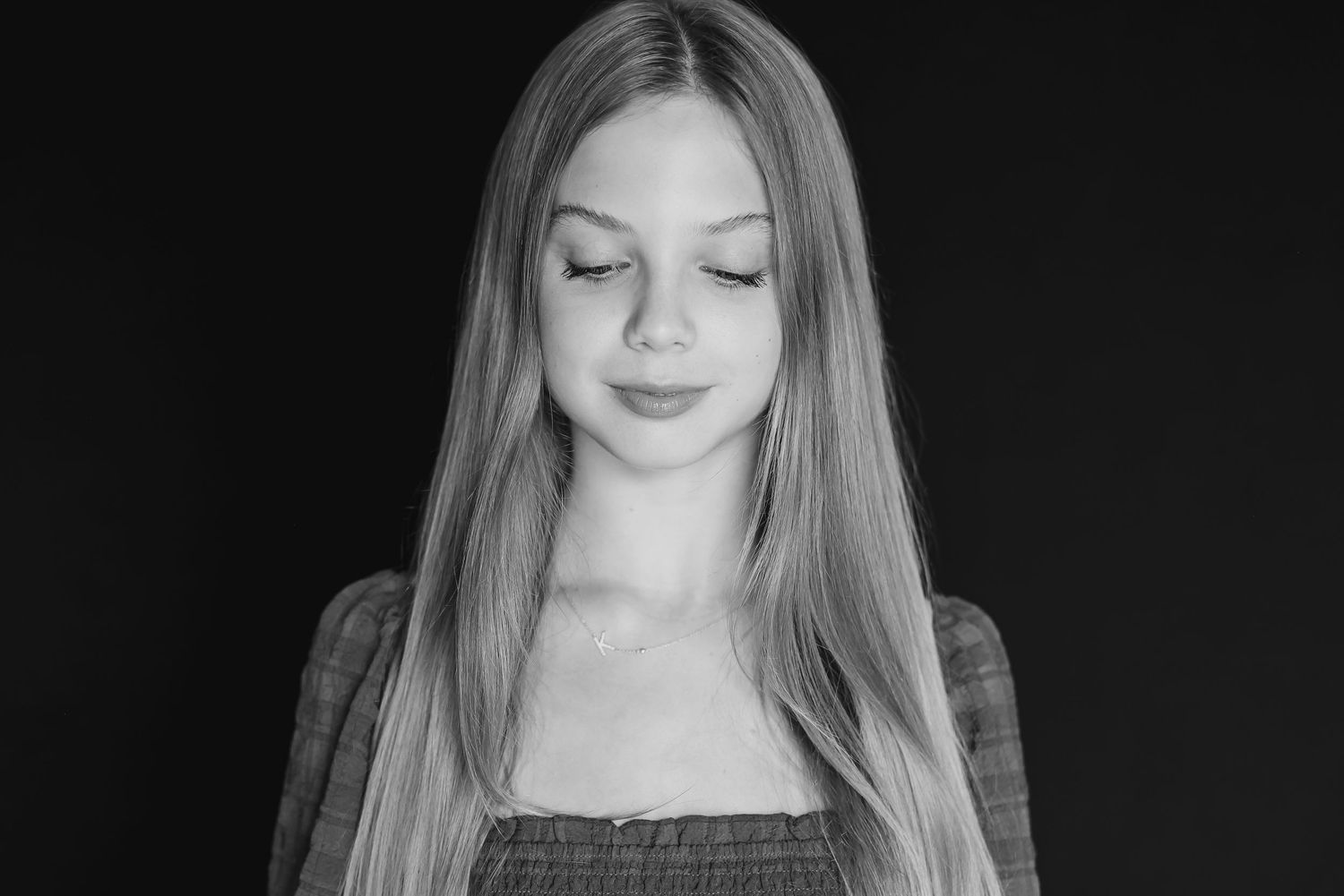 Black and white portrait showing peaceful expression and long flowing hair.