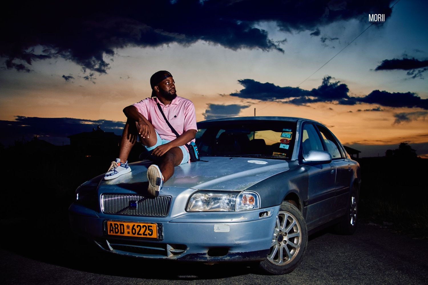 man sitting on a car