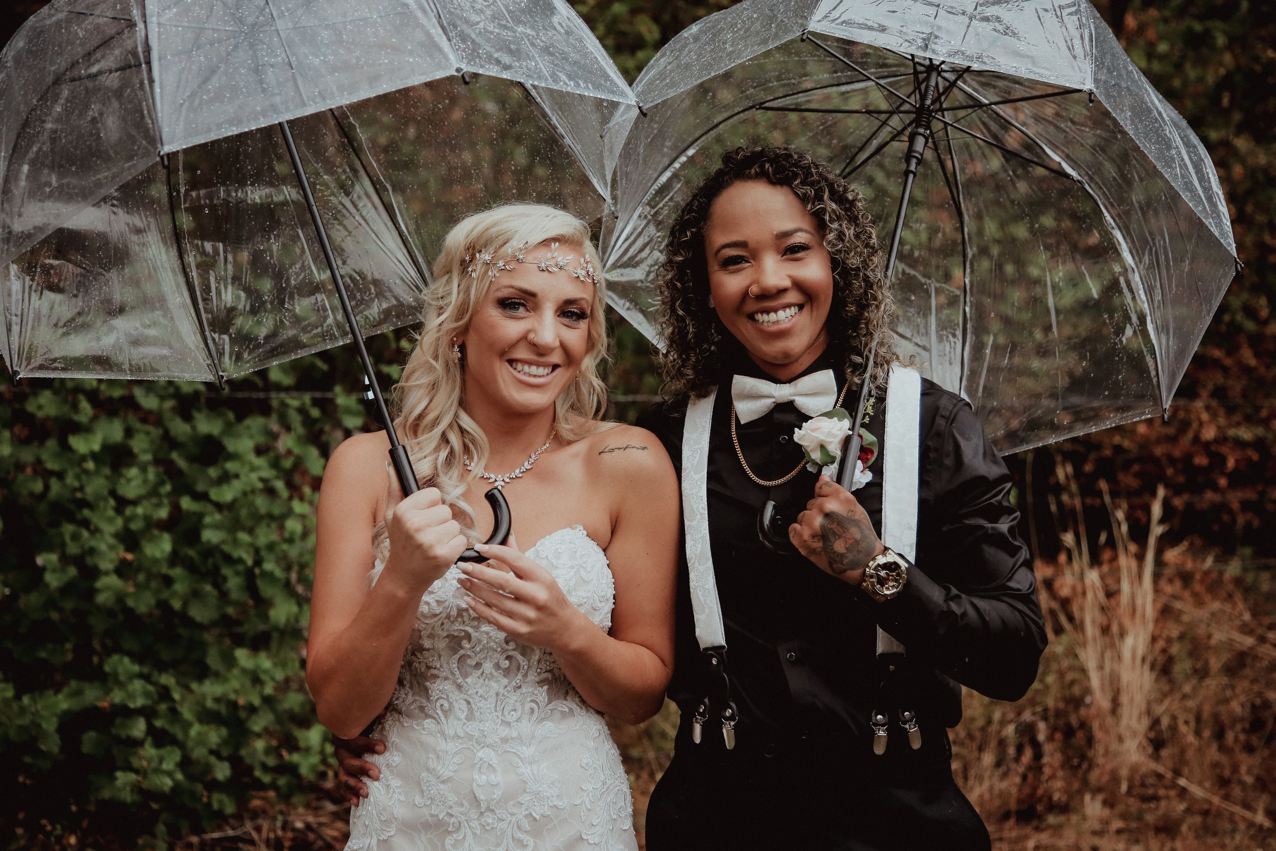 Wedding portraits with clear umbrellas in a forest setting.