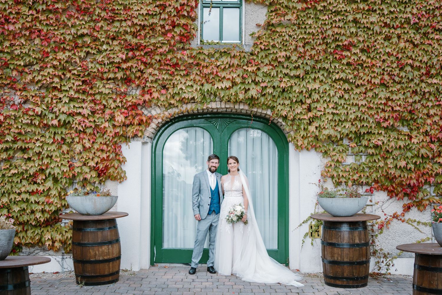 bride and groom in doorway surrounded by ivy