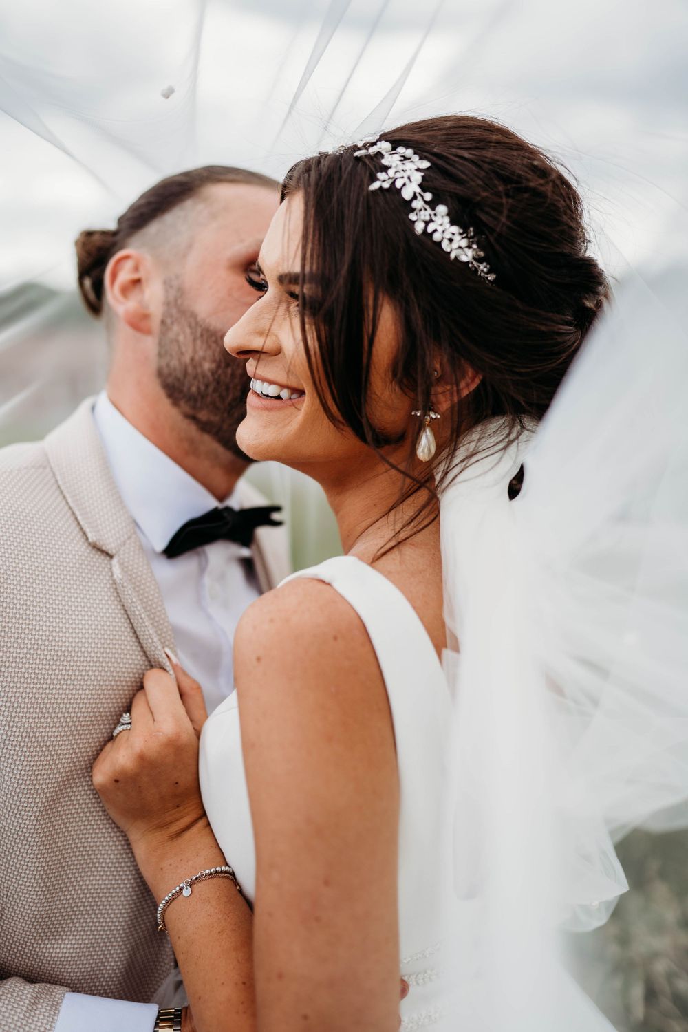 Intimate wedding portrait shows tender moment between newlyweds.