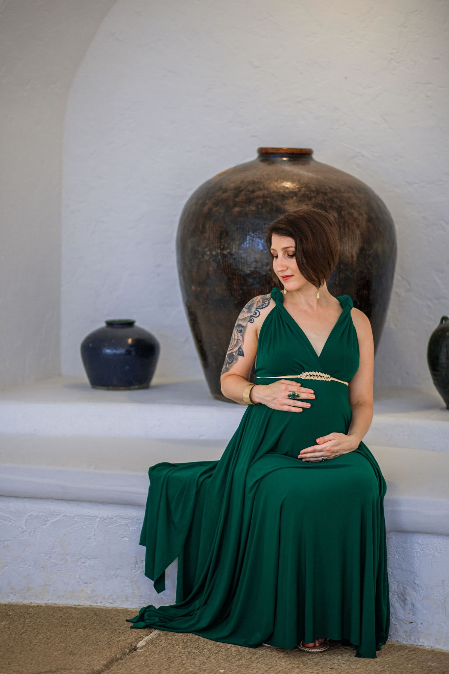 Maternity portrait in Gauteng featuring expectant mother in flowing green dress with elegant, timeless styling