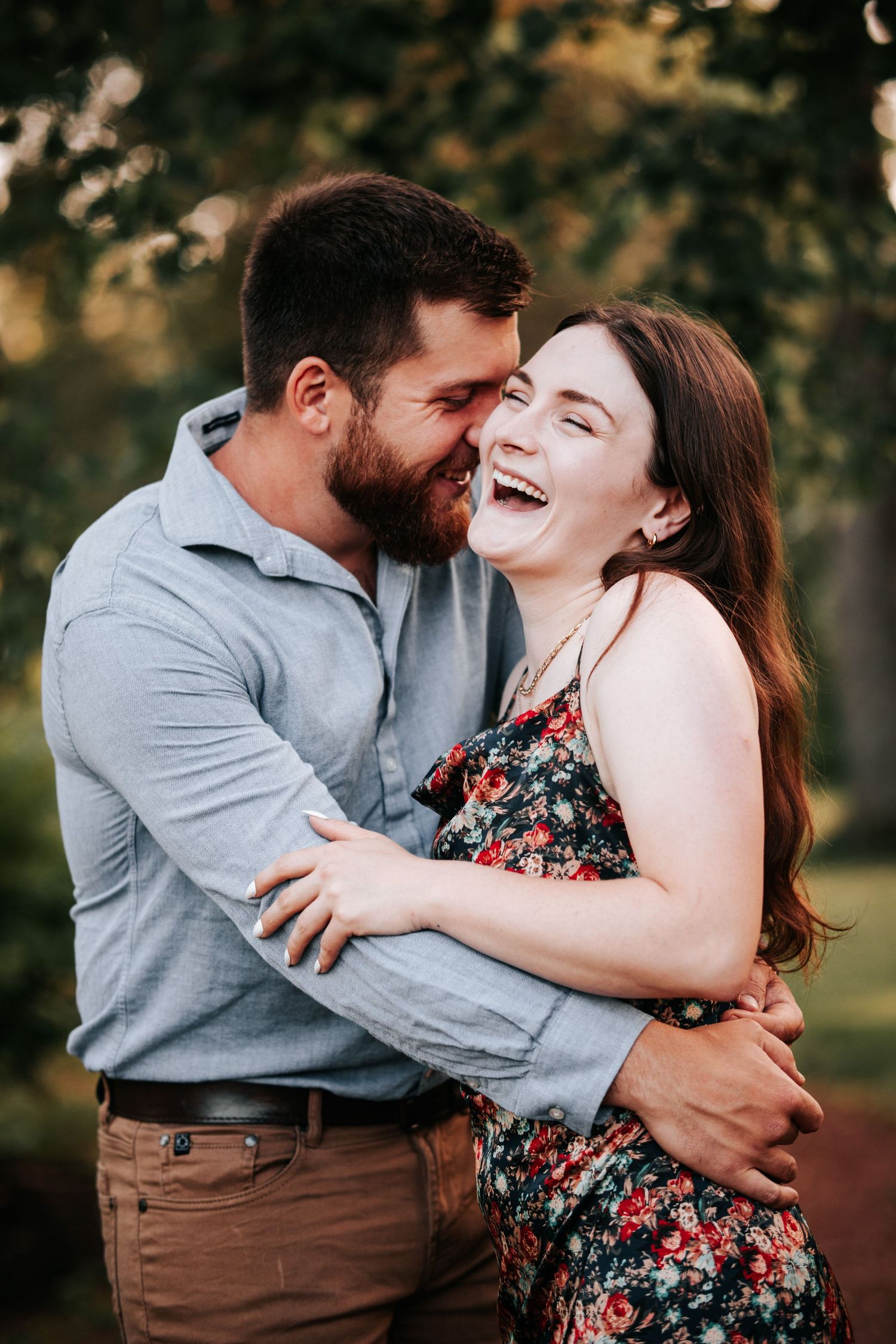 Couple sharing a joyful laughing moment outdoors.
