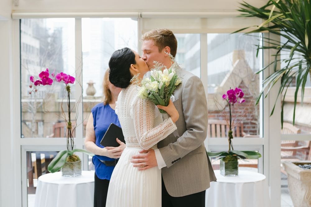newlyweds share their first kiss after being declared husband and wife, photo by MYC elopement photographer Paula Ortiz