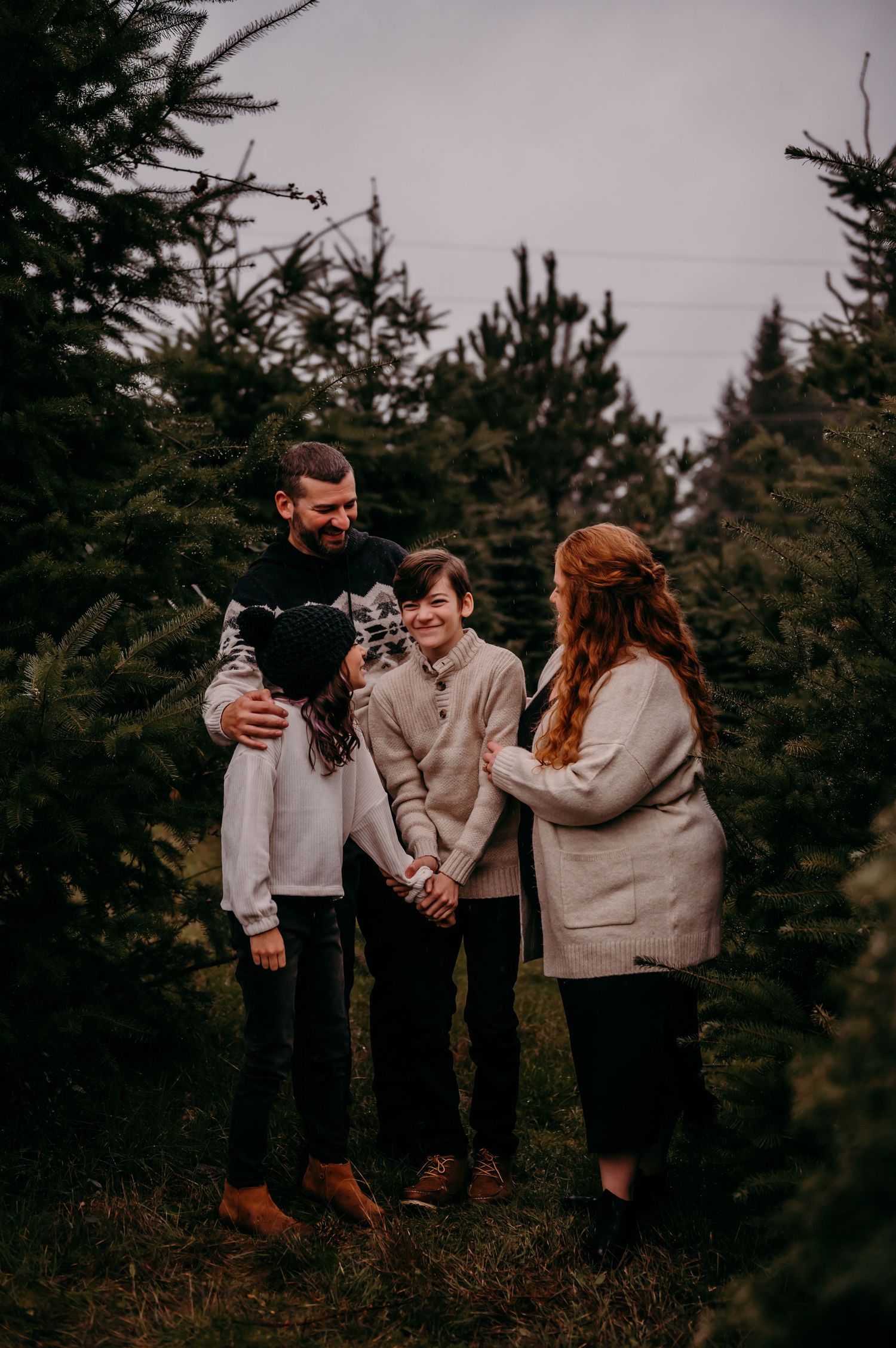 Family stands together in the trees