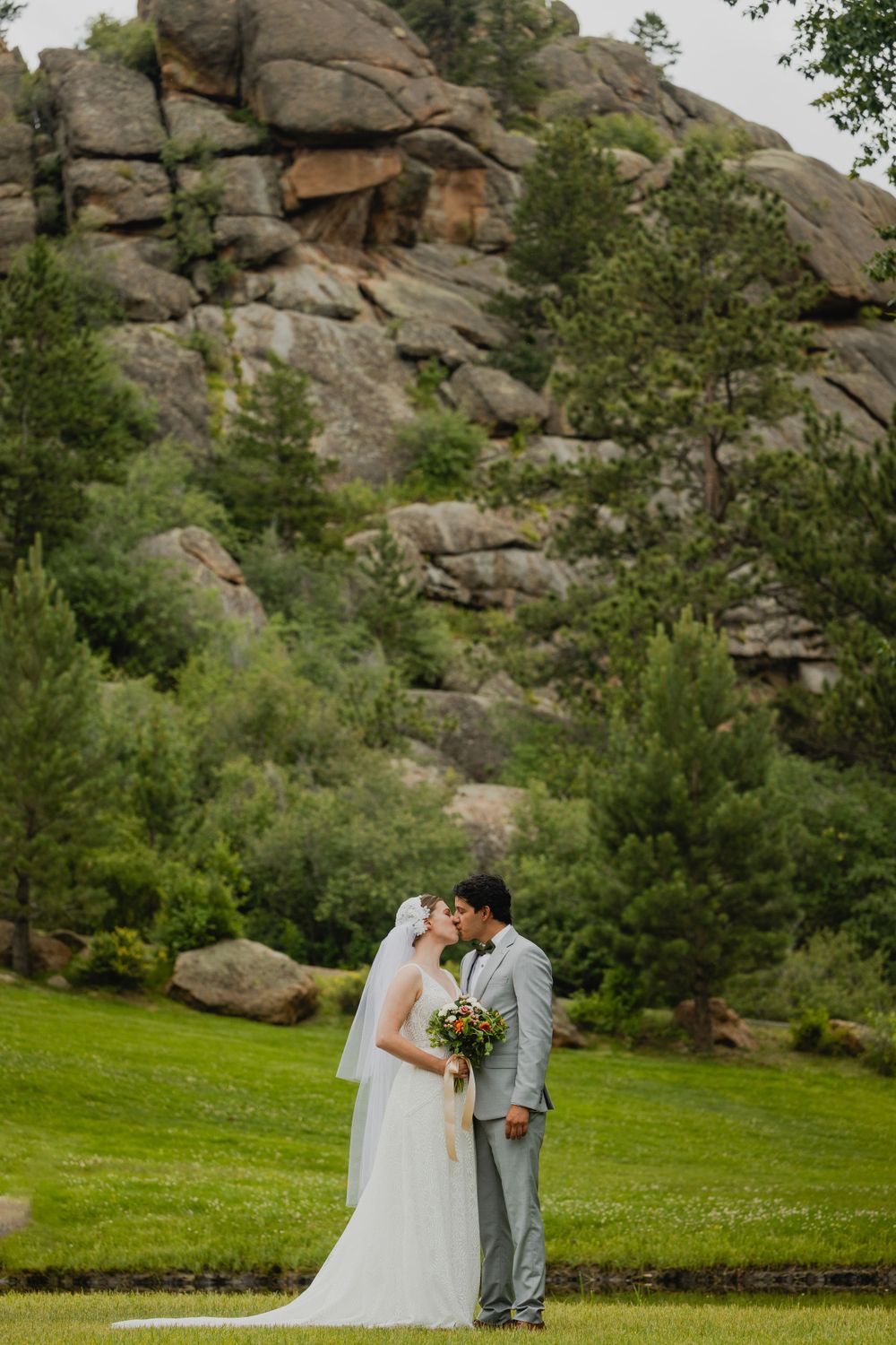 Wedding couple holding hands in front of the picturesque Black Canyon Inn scenery.