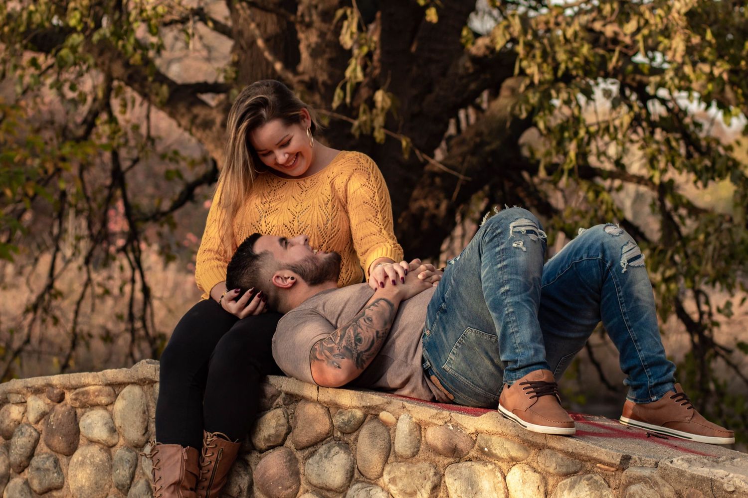 Jaime and Felipe's Romantic look at the bridge in the fall season at warinanco Park in Elizabeth New Jersey.