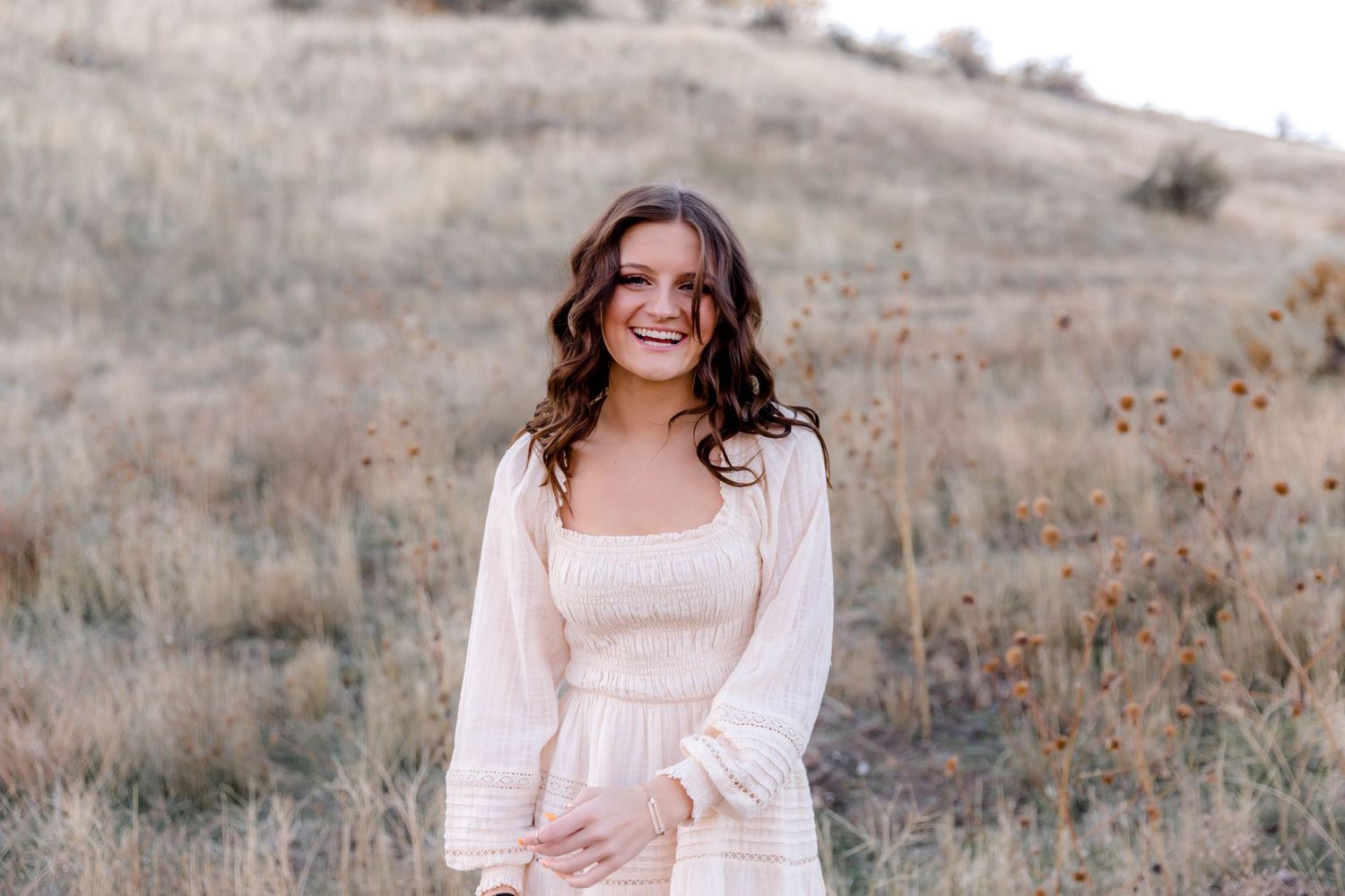 Mialee walking and laughing in the Boise foothills for her senior pictures in the fall.