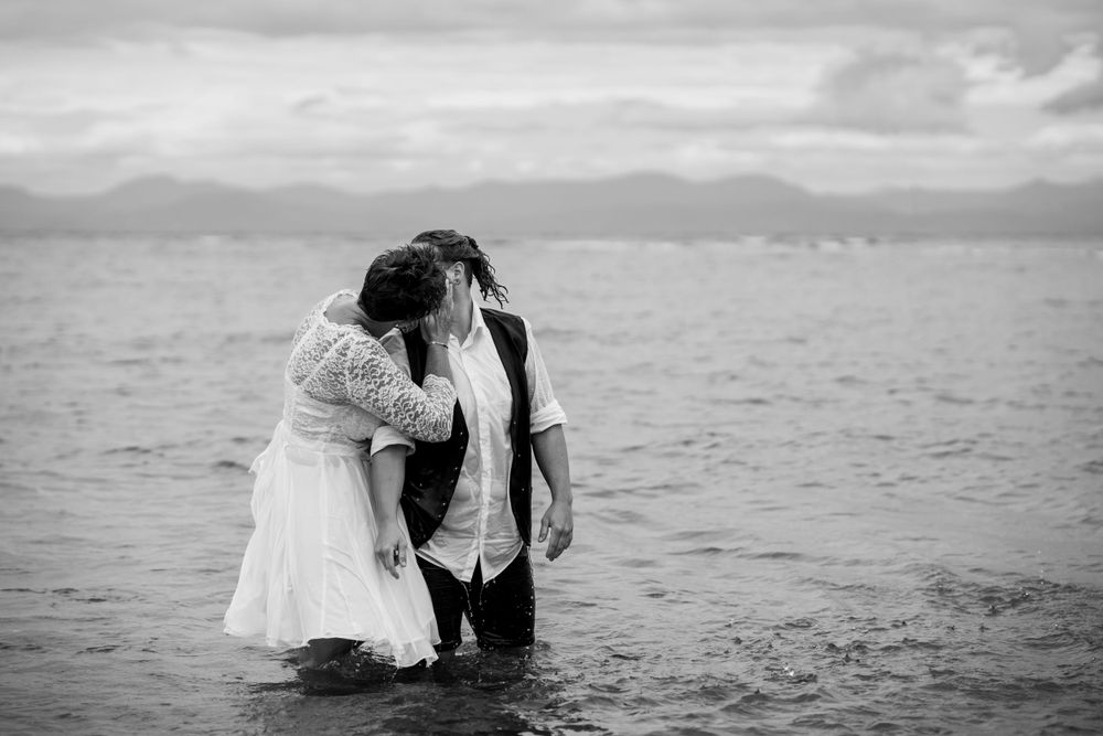 brides kissing in the ocean, same sex wedding NZ, same sex wedding photographer NZ, beach elopement, black and white,
