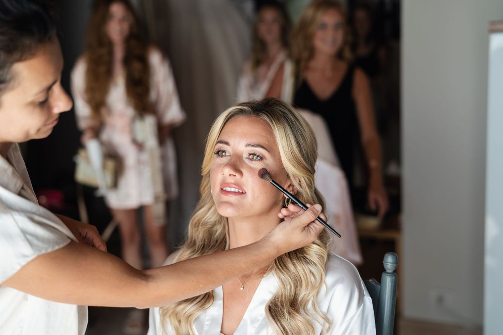 Final touches of bridal preparation in a dimly lit room.