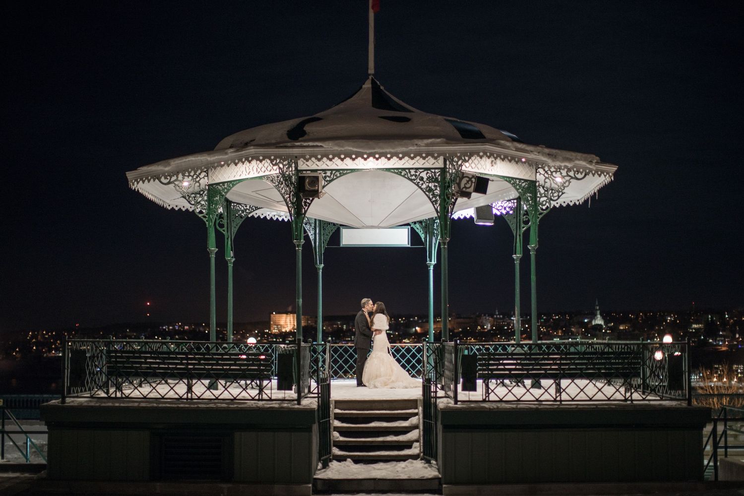 a couple in a gazebo near chateau frontenac night winter