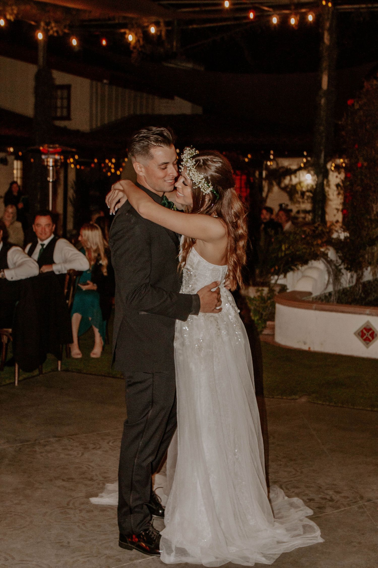 Newlyweds celebrate during their wedding reception with their first dance.