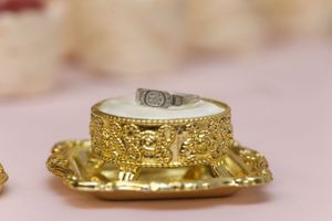 Close-up details of ornate gold wedding accessories and decorative elements.