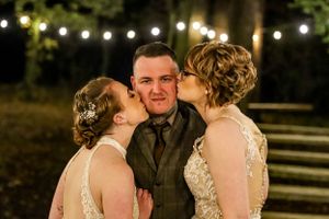 A candid moment captured under string lights during an evening celebration.