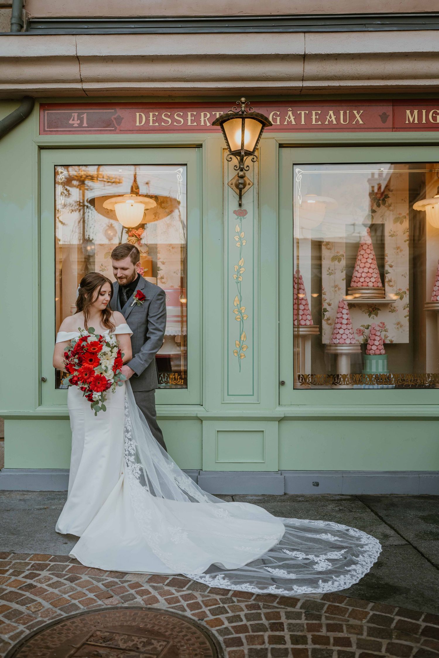 Bride and groom share a tender moment outside a French patisserie storefront at Epcot's France pavilion.