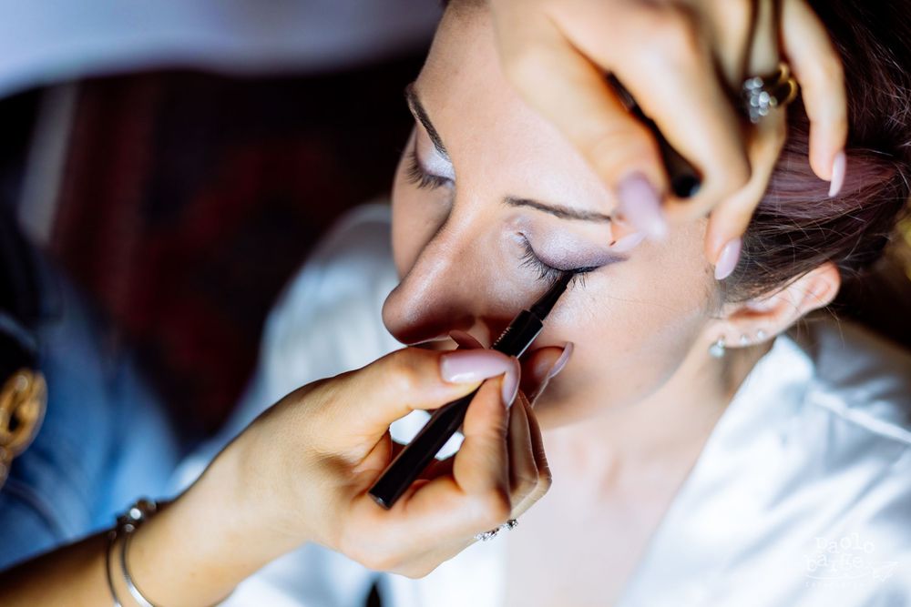 Close-up shot of makeup application during bridal preparation.