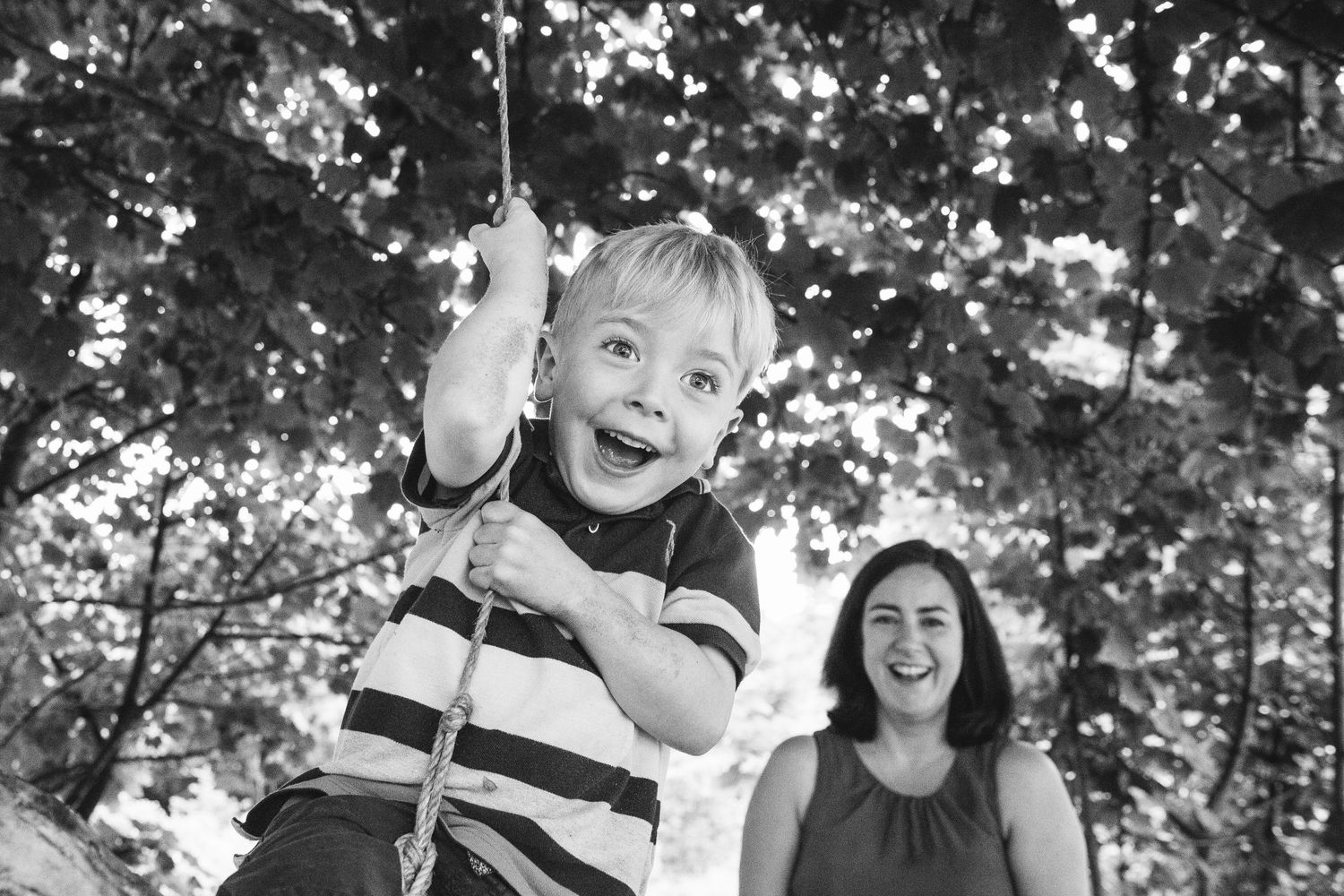 Joyful moment captured on a tree swing on a sunny summer day.