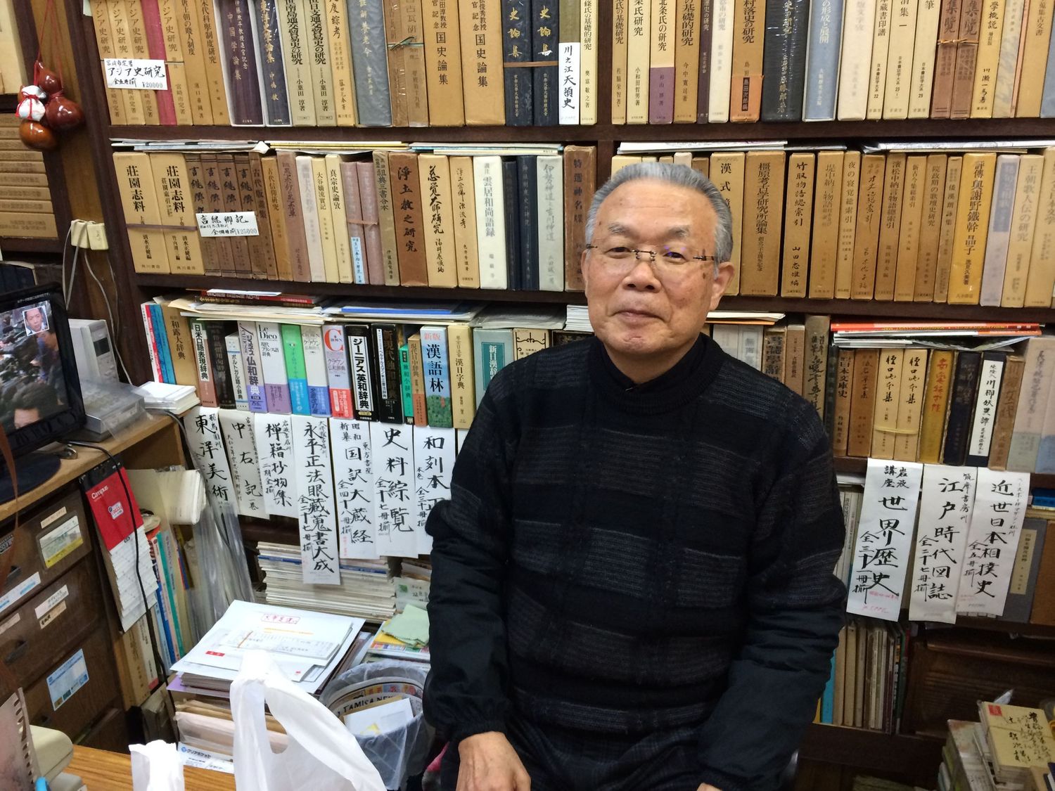 Environmental portrait of book shop owner in Kyoto Japan