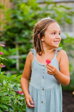 little girl picking flowers in garden during birthday photoshoot Panama City Florida